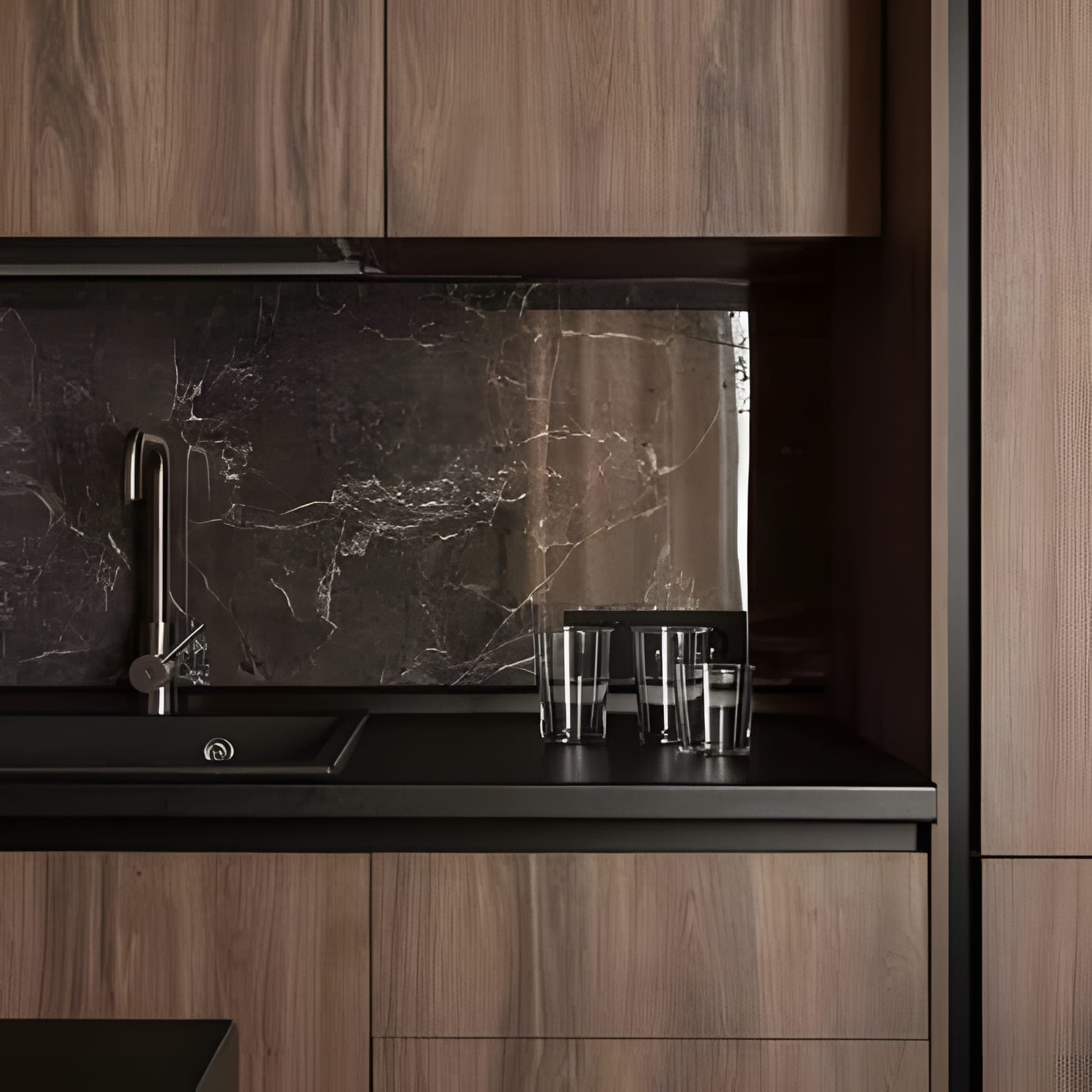 Dark walnut cabinetry against a black marble backsplash, coffee-toned and unhurried.