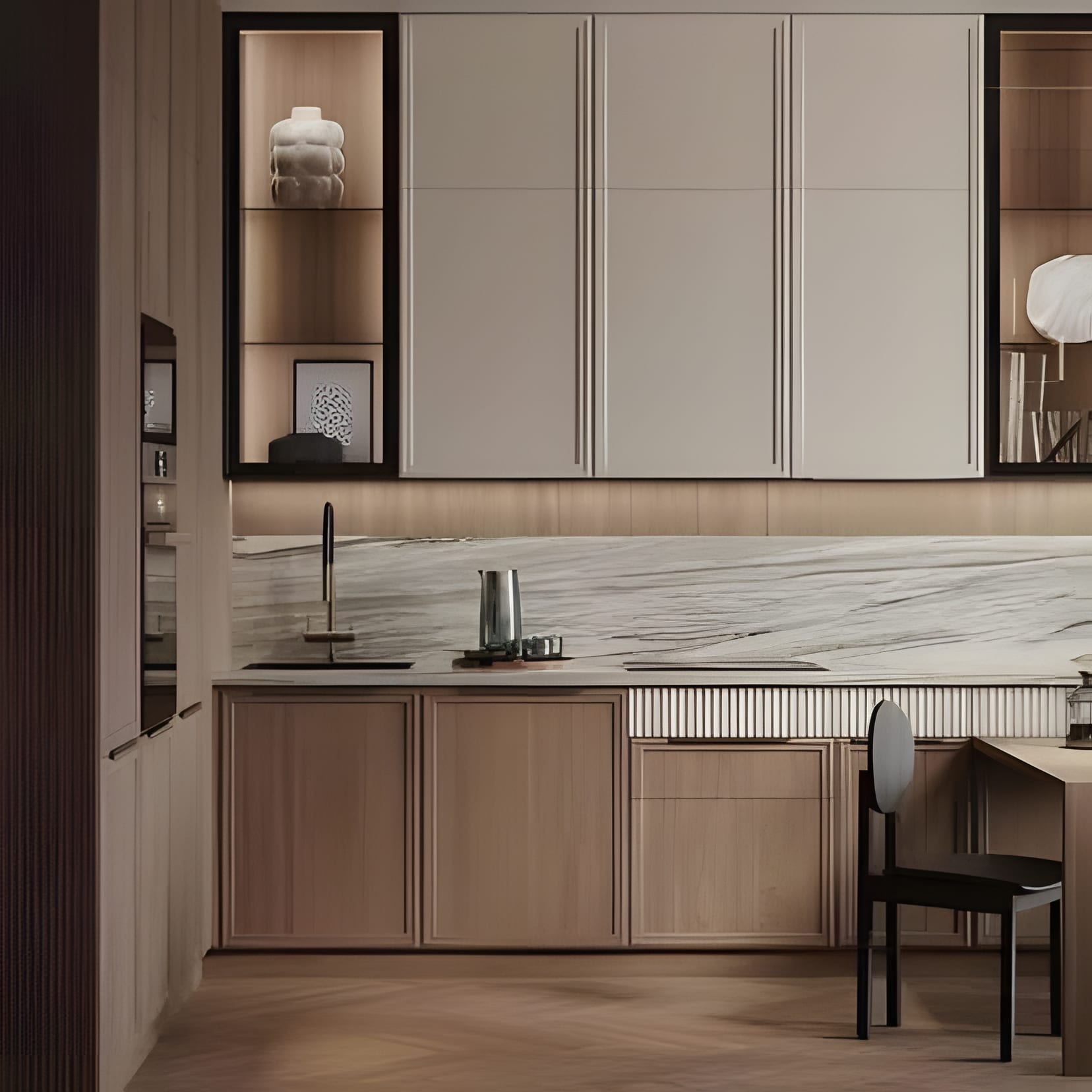 Cream and oak cabinetry with a bold marble slab backsplash and a quiet desk corner at the end of the run.