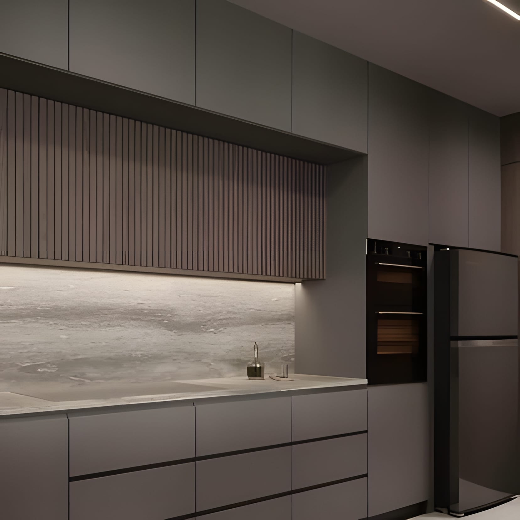 Grey cabinetry with a fluted feature panel over a stone backsplash, a fridge tower at the end.