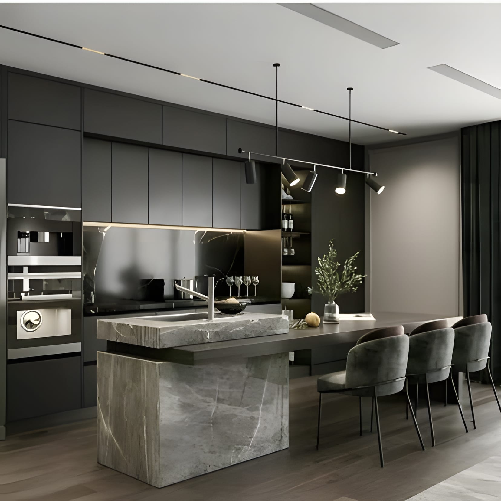 A raw-edged stone island block standing in a grey kitchen, dining table alongside.