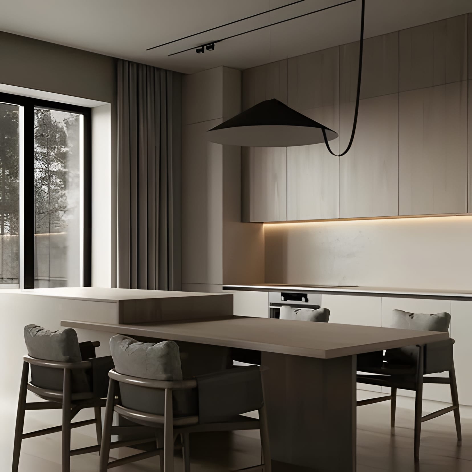 Greige flat-panel cabinetry flowing into a slate-toned island table, with a single black pendant and floor-to-ceiling glass.