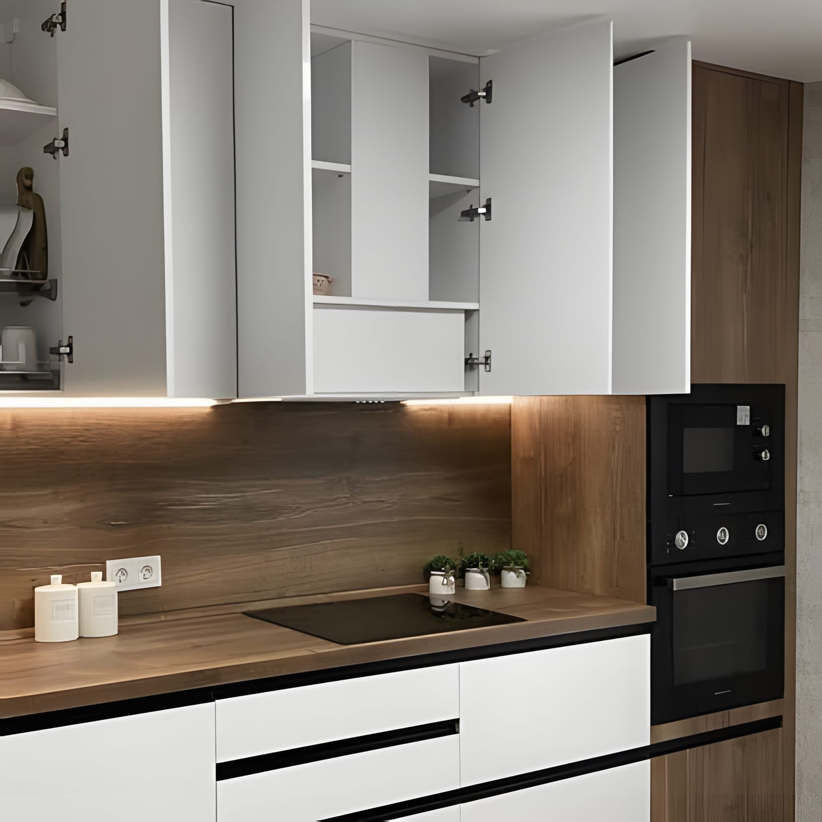 White uppers open over a warm timber backsplash and black hob — breakfast mid-preparation.