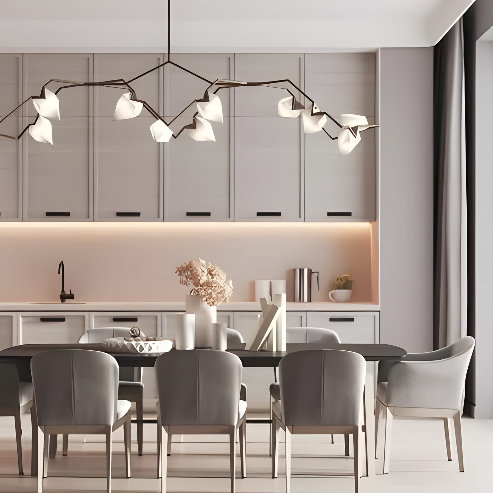 A branching molecule chandelier over a grey dining table, blush light in the coves.