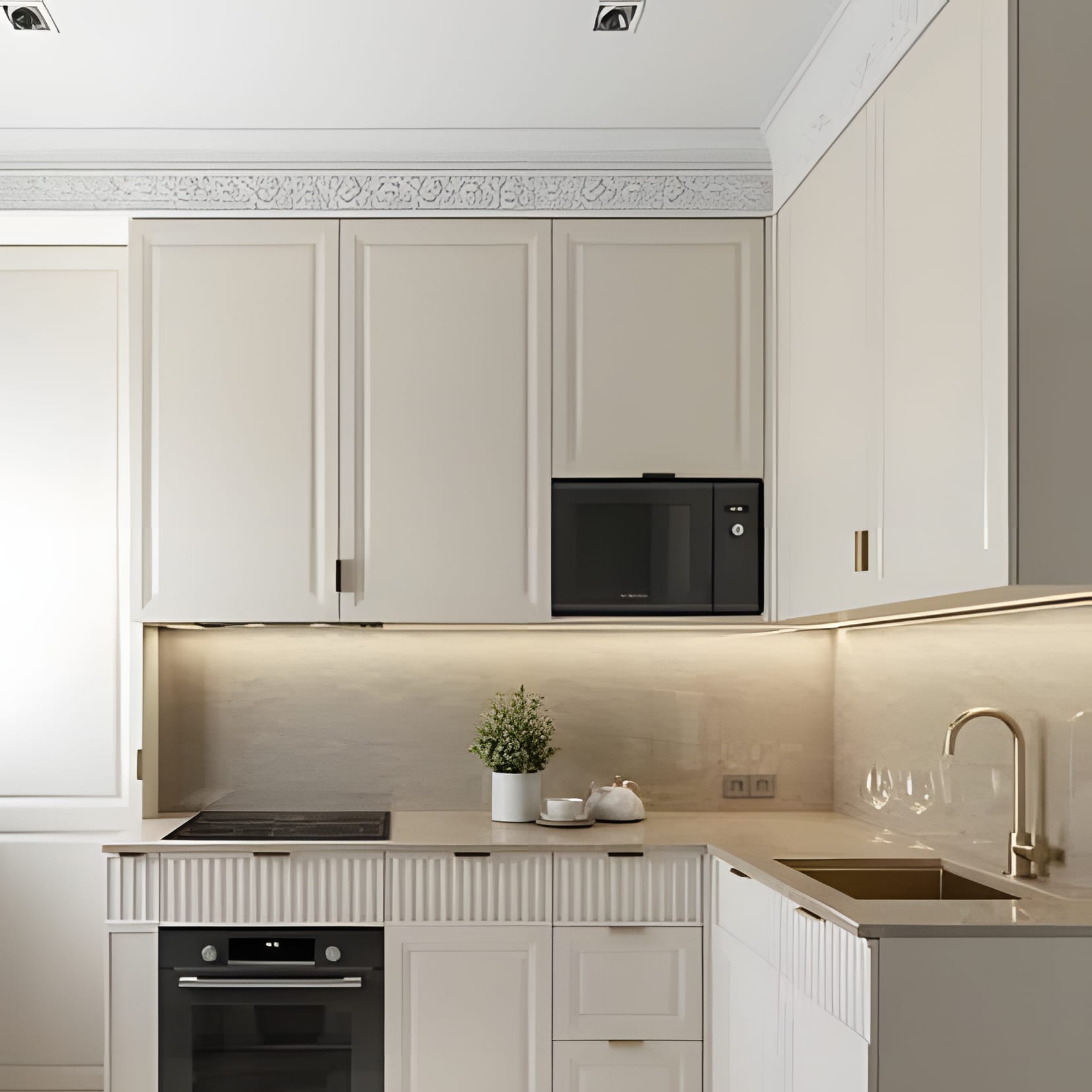 A neat white kitchen with a microwave nook and warm underlighting — small space, no clutter.